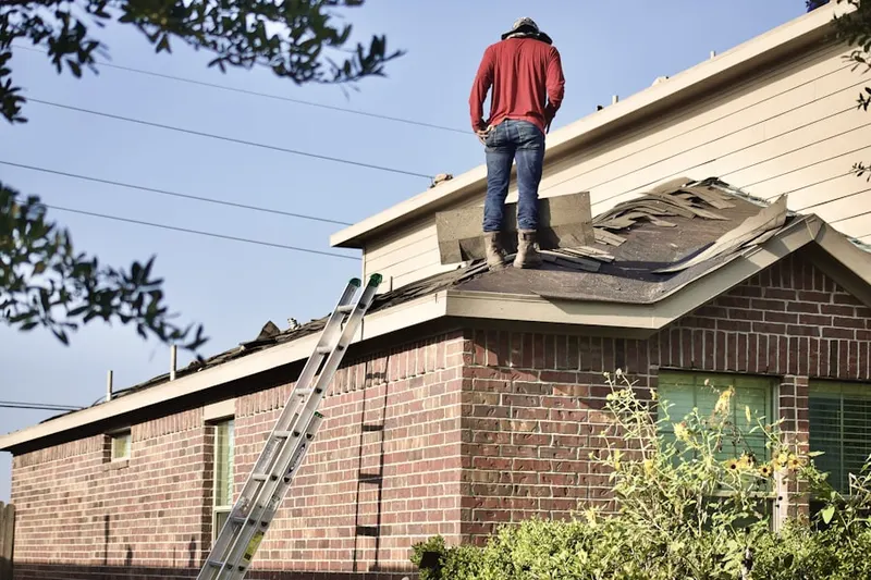 Professional roofer working on a residential roof in North Lancaster